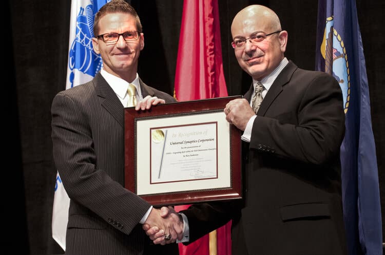 Ken Anderson is presented with the DoD Mx Symposium "Great Ideas" Competition Award in 2012